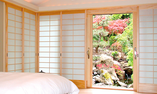 Master bedroom shoji screens slide into a deep pocket on the right side of the window wall
