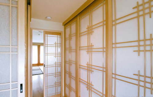 Bipart shoji doors using a barn door style tracking system