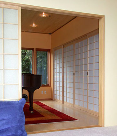 The music room is enclosed in shoji screens, as room dividers and as the audio closet doors.
