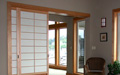 Shoji screens that slide into a wall pocket built in at the framing stage of this project.