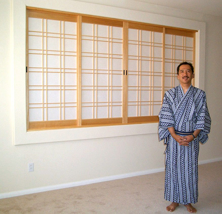 Custom shoji screens in a wall opening between the living room and bedroom.