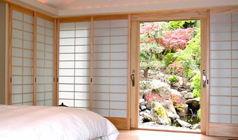 The window wall has wood tracking and all five shoji screens slide into a pocket on the right side of the window wall. 