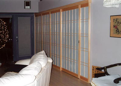 Fixed shoji panels cover wall and create a pocket for the sliding shoji door