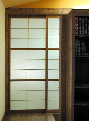 The slding shoji door in the wall built of Japanese shoji screens.