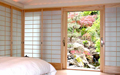 The window wall has wood tracking and all five shoji screens slide into a pocket on the right side of the window wall